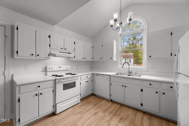 kitchen featuring light wood-type flooring, white appliances, sink, hanging light fixtures, and lofted ceiling