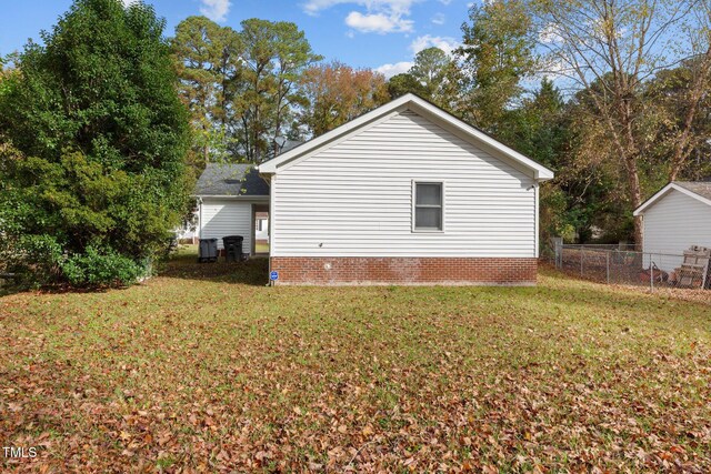 view of side of home featuring a lawn