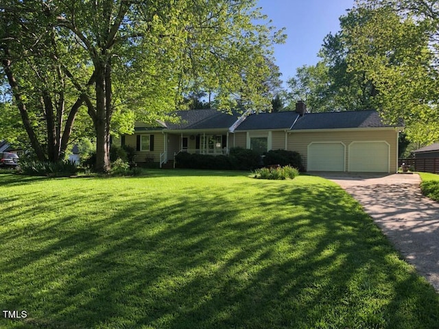 ranch-style house featuring a front lawn and a garage