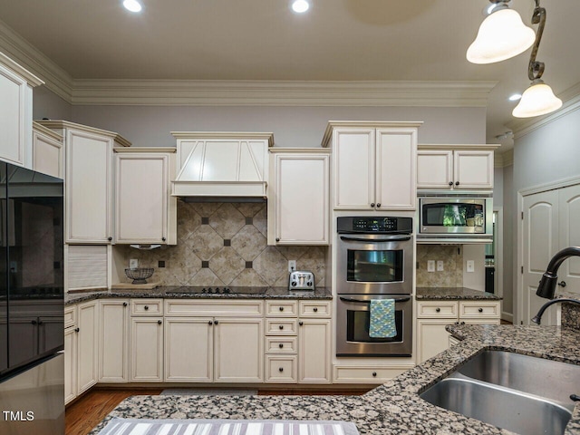 kitchen featuring dark stone countertops, sink, black appliances, premium range hood, and ornamental molding