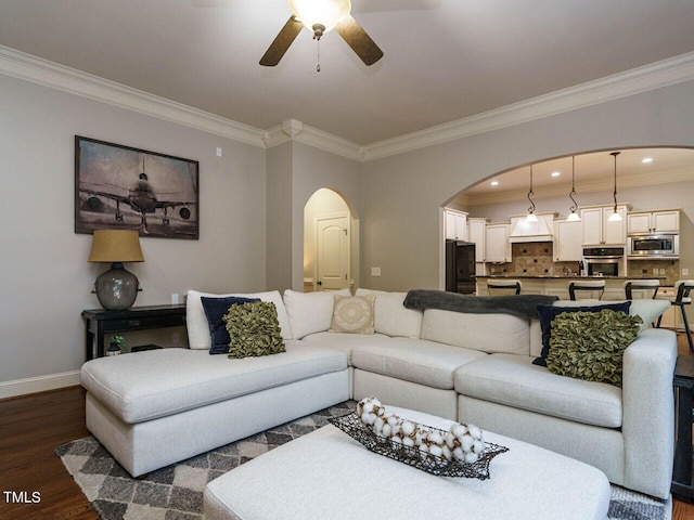 living room featuring crown molding, ceiling fan, and dark hardwood / wood-style floors