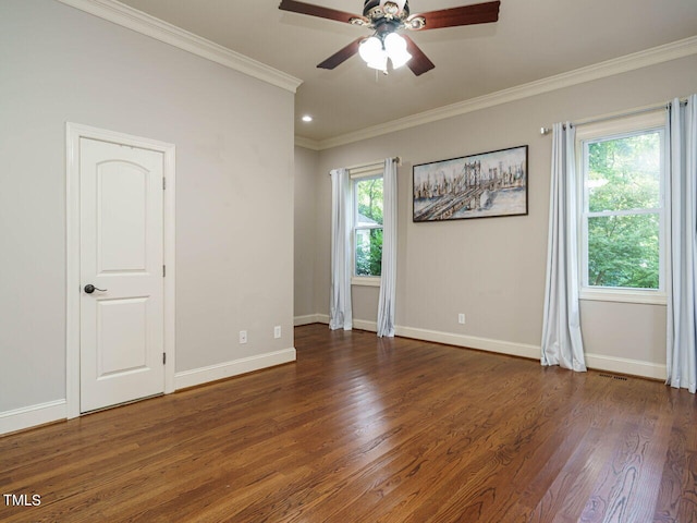 unfurnished room featuring ornamental molding, a wealth of natural light, ceiling fan, and dark hardwood / wood-style floors