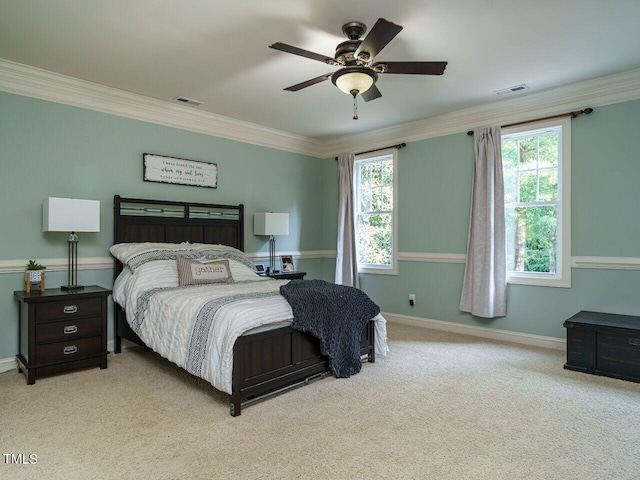 bedroom with crown molding, light colored carpet, and ceiling fan