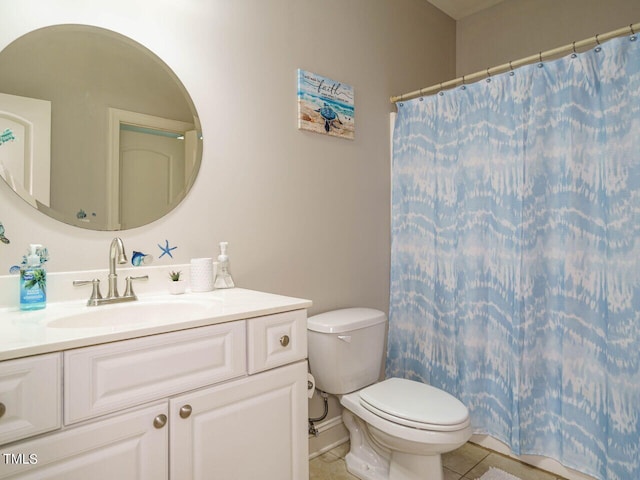 bathroom with tile patterned flooring, vanity, and toilet