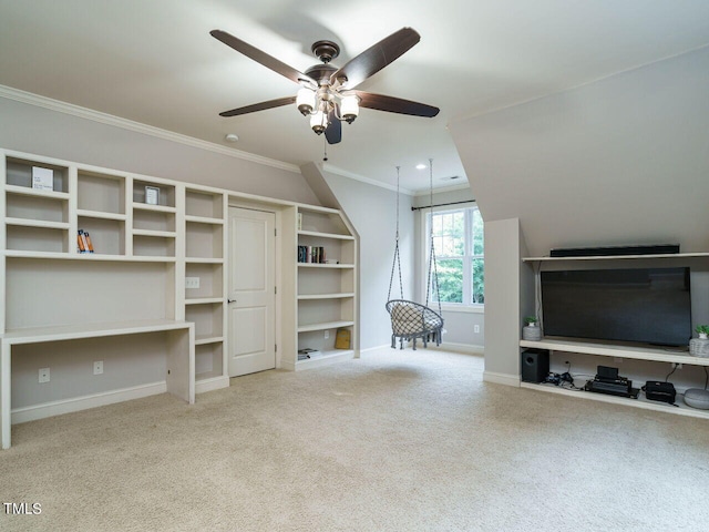 unfurnished living room featuring carpet flooring, ceiling fan, and ornamental molding