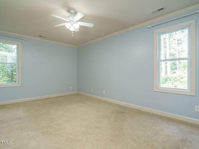 unfurnished room with ceiling fan, light colored carpet, and ornamental molding