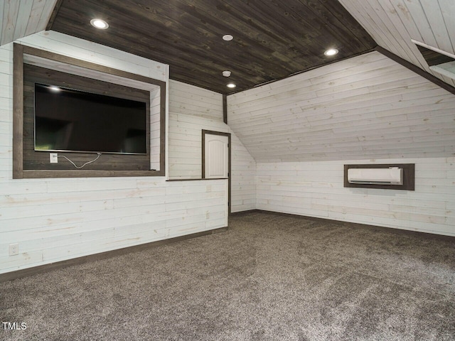 unfurnished living room featuring wooden ceiling, vaulted ceiling, wooden walls, and carpet