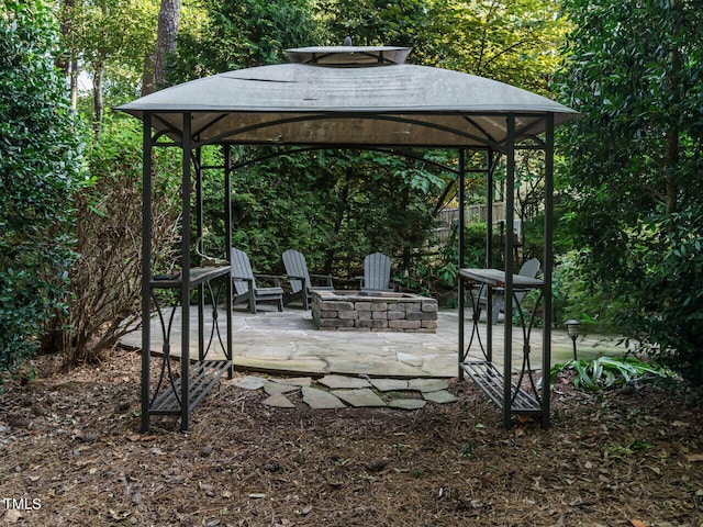 view of patio with an outdoor fire pit and a gazebo