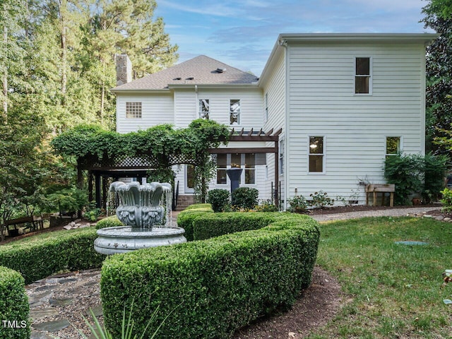 back of property with a pergola