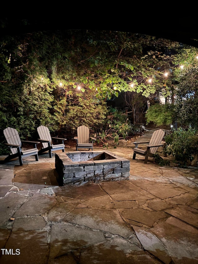 patio at twilight featuring an outdoor fire pit