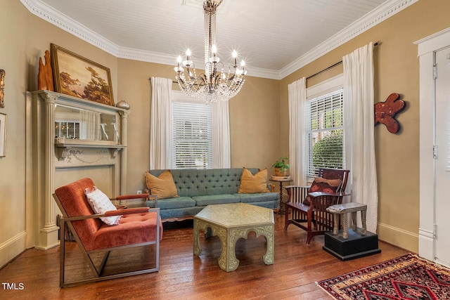 sitting room with ornamental molding, a chandelier, and hardwood / wood-style flooring