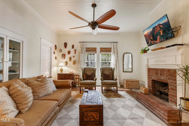 living room with light wood-type flooring, a fireplace, ornamental molding, and ceiling fan