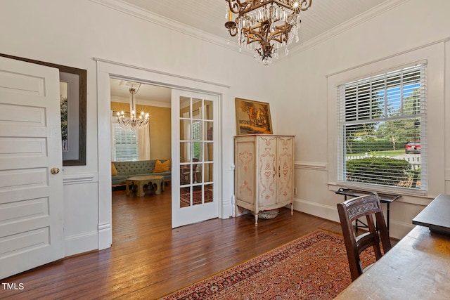 office area with a notable chandelier, ornamental molding, and dark wood-type flooring