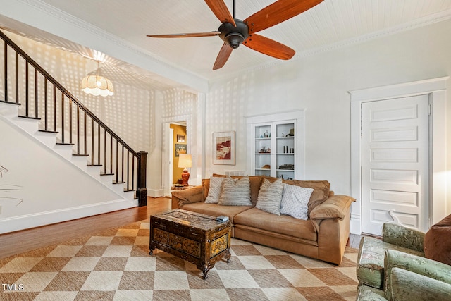 living room with ornamental molding, light hardwood / wood-style floors, ceiling fan, and built in features