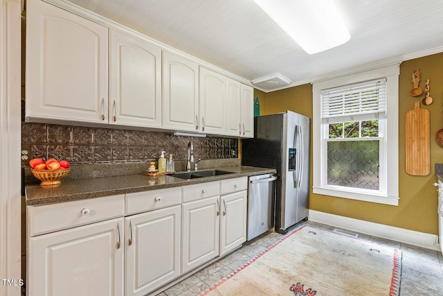 kitchen featuring sink, white cabinetry, decorative backsplash, appliances with stainless steel finishes, and light tile patterned floors