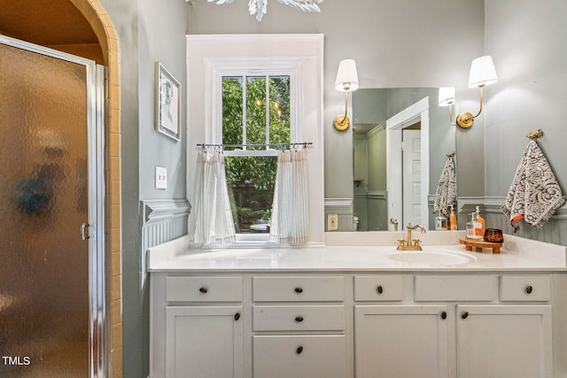 bathroom featuring vanity and a shower with door