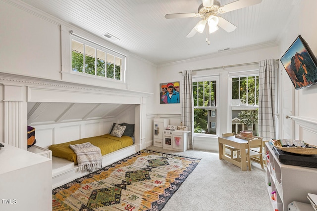 carpeted bedroom featuring ceiling fan and crown molding