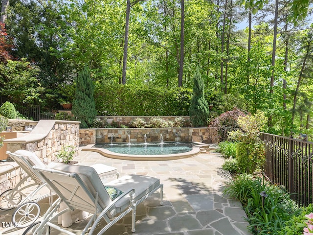 view of swimming pool featuring a patio area and pool water feature