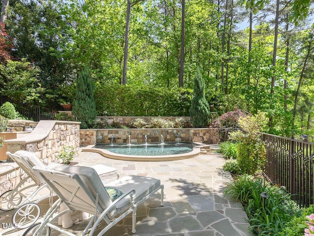 view of swimming pool with fence, a pool, and a patio area