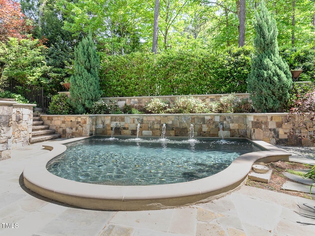 view of swimming pool featuring pool water feature