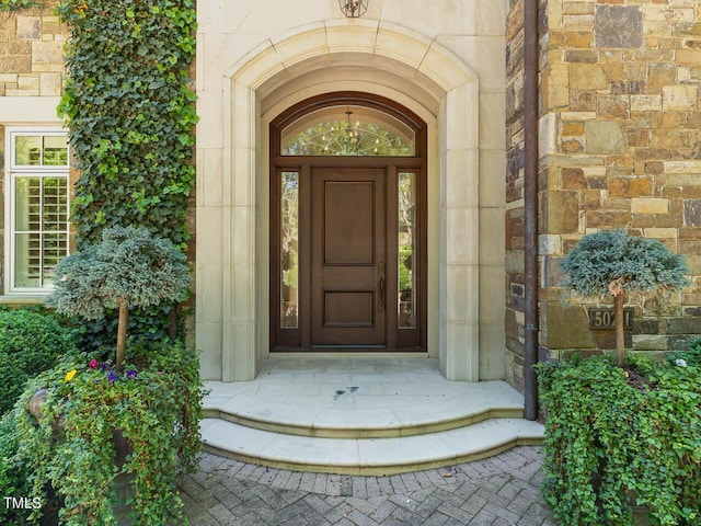 entrance to property featuring stone siding