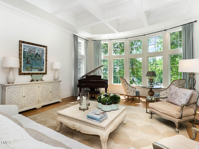 living room featuring a healthy amount of sunlight, coffered ceiling, light wood-type flooring, and beam ceiling