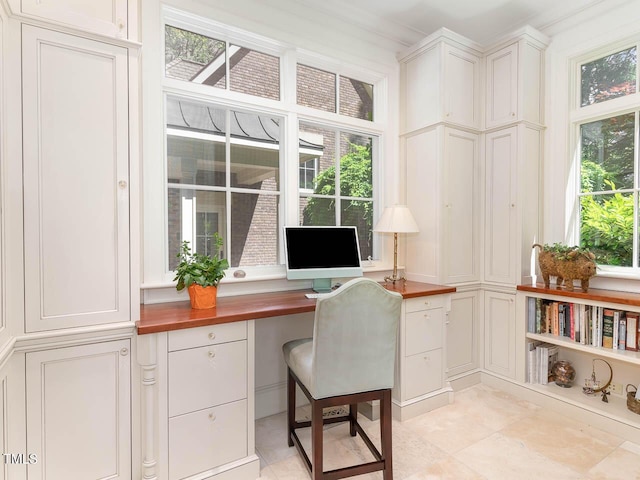 office area with built in desk, light tile patterned floors, and a wealth of natural light
