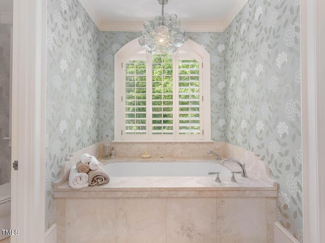 bathroom featuring wallpapered walls, toilet, ornamental molding, and a bath