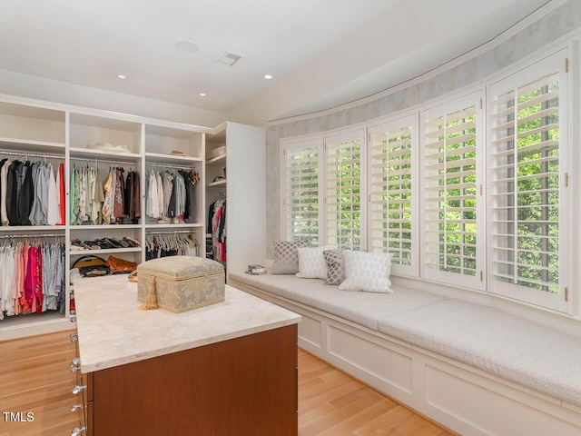 walk in closet with light wood-type flooring