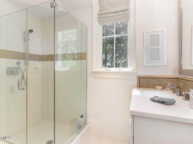 bathroom with an enclosed shower and vanity