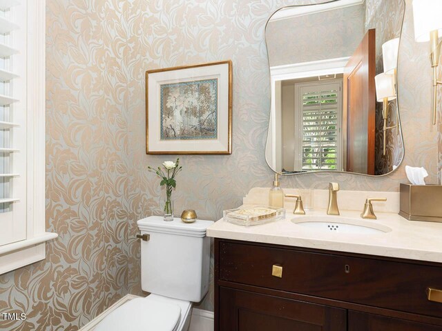 bathroom featuring vanity and toilet