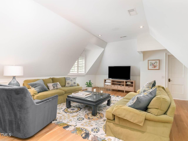 living room with lofted ceiling, visible vents, recessed lighting, and wood finished floors