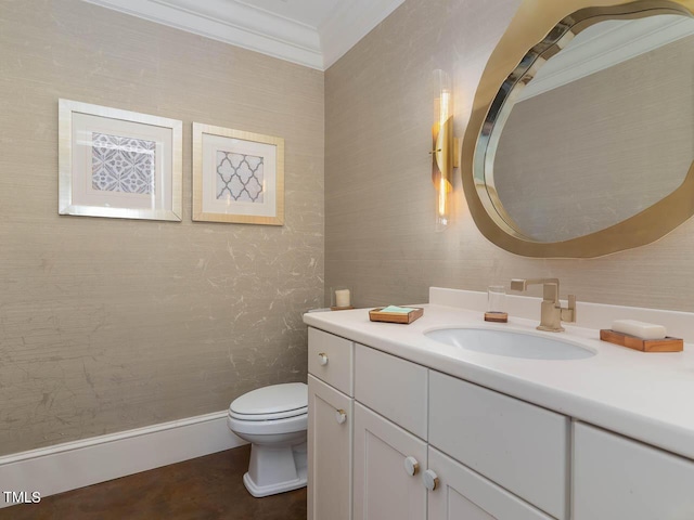 half bath with toilet, vanity, and ornamental molding