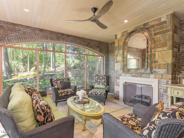 sunroom with a healthy amount of sunlight, ceiling fan, and wooden ceiling