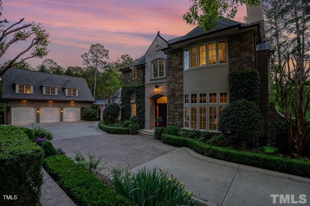 french country inspired facade with a garage