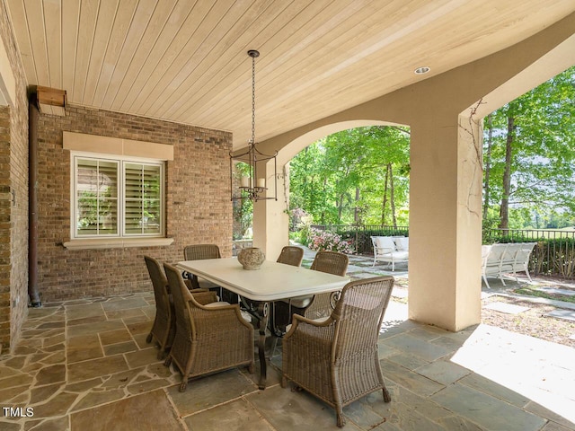 view of patio featuring outdoor dining space and fence