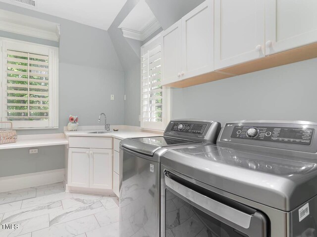 washroom featuring washing machine and clothes dryer, a healthy amount of sunlight, cabinets, and ornamental molding