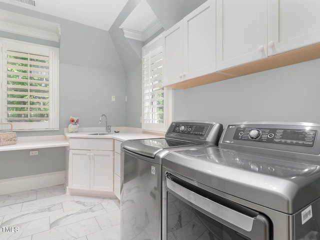 clothes washing area with a sink, marble finish floor, washer and dryer, cabinet space, and ornamental molding