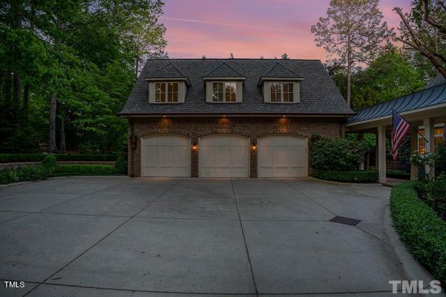 view of front of house with driveway and brick siding