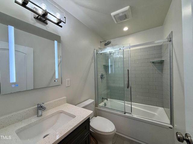 full bathroom featuring toilet, vanity, wood-type flooring, and shower / bath combination with glass door