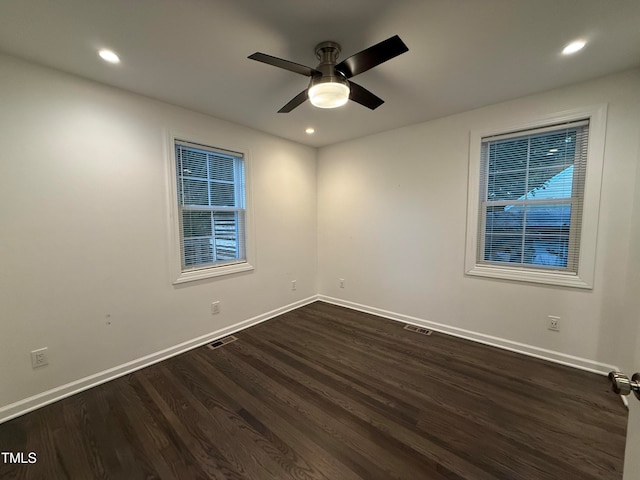 unfurnished room with ceiling fan and dark hardwood / wood-style flooring