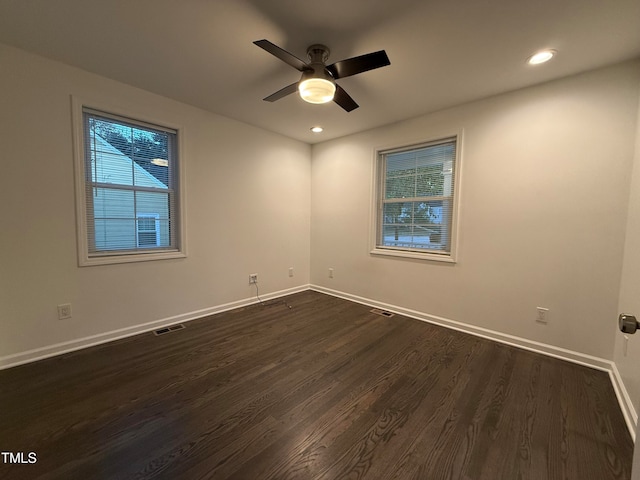 unfurnished room with dark hardwood / wood-style floors and ceiling fan