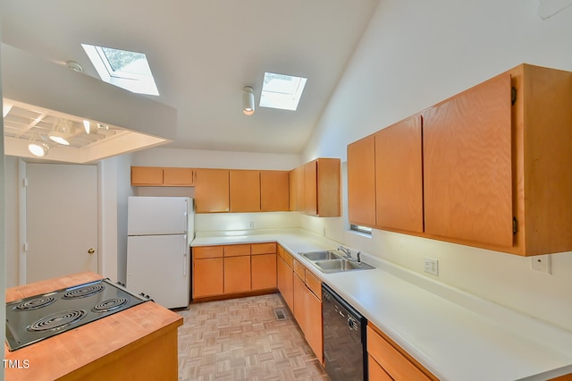 kitchen featuring black appliances, light parquet flooring, sink, and lofted ceiling with skylight