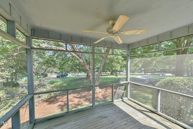 unfurnished sunroom featuring ceiling fan