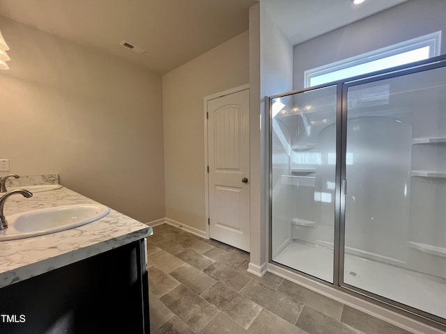 bathroom with vanity and a shower with shower door