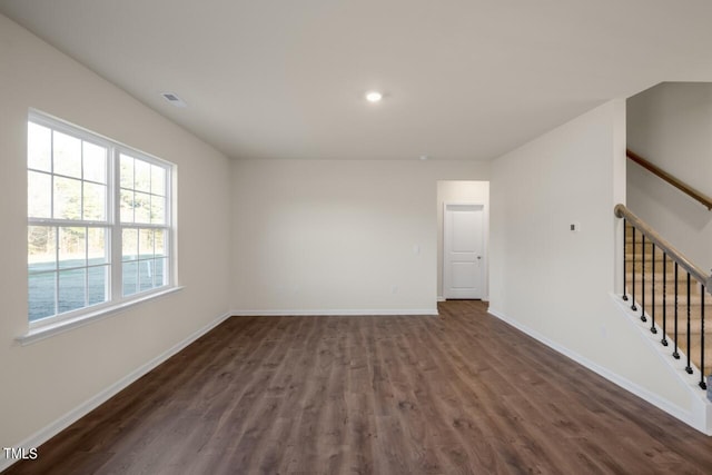 spare room with dark hardwood / wood-style floors