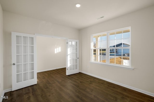 unfurnished room with dark wood-type flooring and french doors