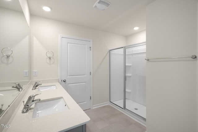 bathroom with vanity and a shower with shower door