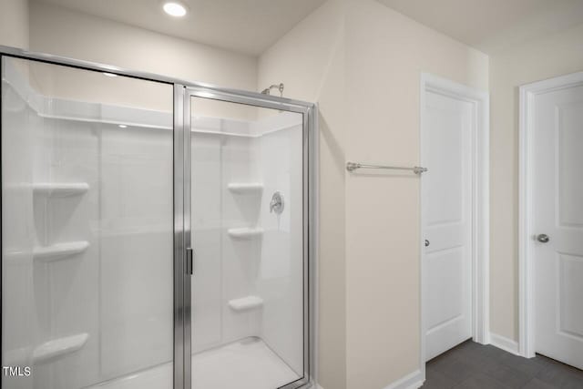 bathroom with a shower with shower door