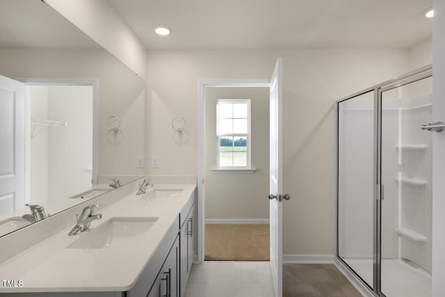 bathroom with vanity and a shower with shower door